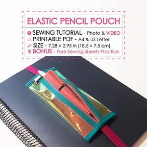 Op de afbeelding: Een doorzichtige, iriserende etui met een turquoise rits en rand, met een roze pen. De etui is bevestigd aan een donkergrijze notitieboek met een roze elastiek. Tekst: "ELASTIC PENCIL POUCH". Afmetingen: 18,5 x 7,5 cm.
