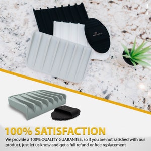 May include: A set of three grey, white, and black silicone dish soap holders with a black brush. The dish soap holders have ridges to hold the soap and the brush has bristles to scrub dishes. The text "EFFILOGIC" is printed on the black brush.