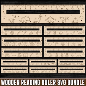 May include: A collection of light-colored wooden reading rulers featuring laser-cut designs including dinosaurs, space themes, farm animals, sea creatures, school supplies, camping gear, vehicles, and garden motifs, each with a 15 cm measurement scale.