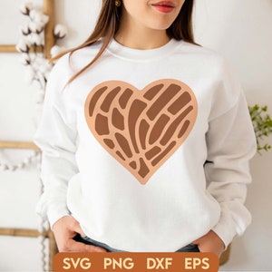 May include: A white sweatshirt with a brown heart-shaped design. The heart has a geometric pattern of lines and curves.