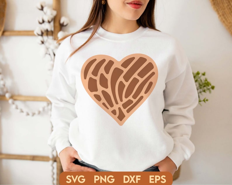May include: A white sweatshirt with a brown heart-shaped design. The heart has a geometric pattern of lines and curves.