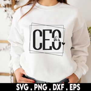 May include: White sweatshirt with black text that reads "CEO she is" inside a black outlined box with a small black heart to the right of the text.