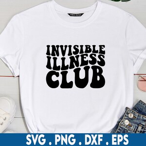 May include: White t-shirt with black text that reads "Invisible Illness Club" in a retro font.