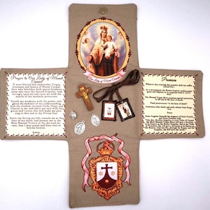 May include: A beige religious item featuring an image of the Virgin Mary and child, surrounded by text and small religious objects. Includes a cross, medals, and a decorative emblem. The item is open, revealing its contents.