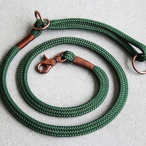May include: A green rope dog leash with copper hardware, including a clip and two rings.