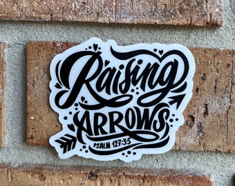 May include: White sticker with black lettering that says "Raising Arrows" with an arrow pointing to the right. Below the text is "Psalm 127-35".