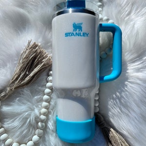 40 oz authentic Stanley tumbler with white glitter and teal handle and spinner. Made to order