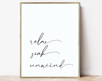 May include: A black and white printable wall art print with the text "relax soak unwind" in a cursive font.