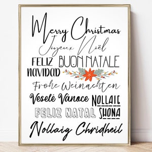 May include: A framed print with the words "Merry Christmas" in a cursive font, along with greetings in multiple languages. A festive floral design with red and green accents is centered below the greetings.