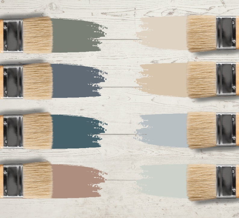 May include: Eight paintbrushes with natural bristles and silver ferrules, each displaying a different color swatch. The colors include shades of gray, blue, and beige, arranged on a white wooden surface.