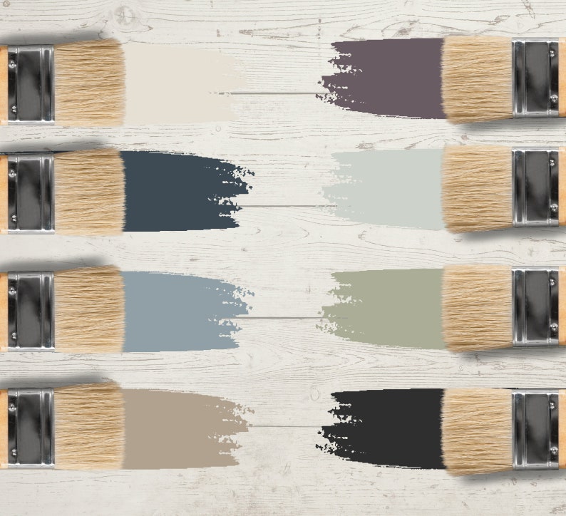 May include: Eight paintbrushes with natural bristles and wooden handles, each displaying a different color swatch. The colors include shades of beige, blue, gray, and black, arranged on a white wooden surface.