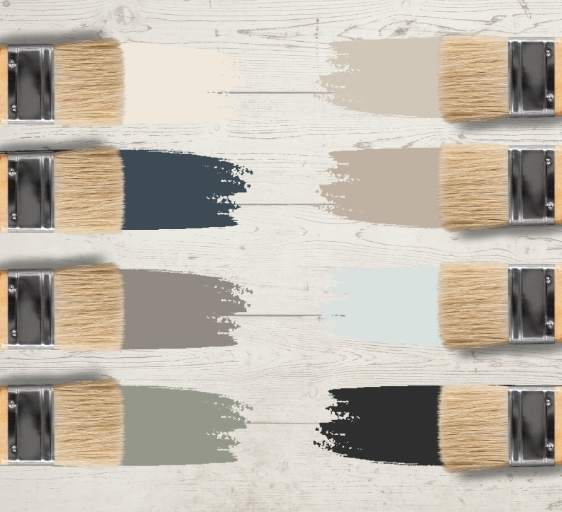 May include: An overhead shot of eight paintbrushes, each with a different color swatch. The colors include cream, navy blue, taupe, light blue, gray, and black. The paintbrushes are arranged on a white wooden surface.