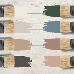 以下が含まれることがあります： さまざまな色のペイント見本が付いた絵筆のコレクション。色はクリーム色、濃い緑色、明るい灰色、青色、タン色、モーヴ色、濃い茶色、明るいピンク色など。絵筆は白い木製の表面に配置されています。