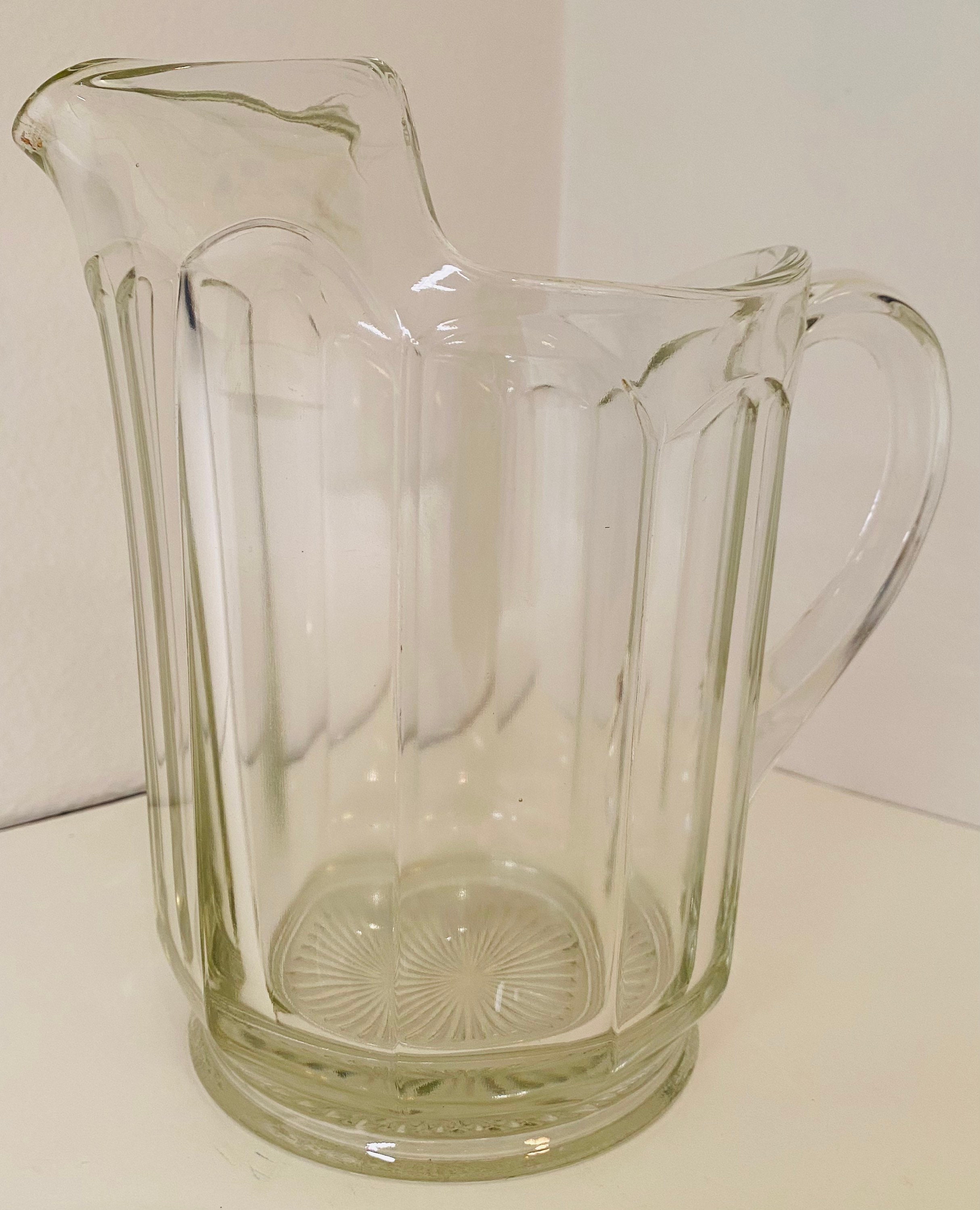 Vintage Heavy Pressed Glass Pitcher with Ribbon Edge Design, Starburst Bottom and Curved Decorative Ice Lip.