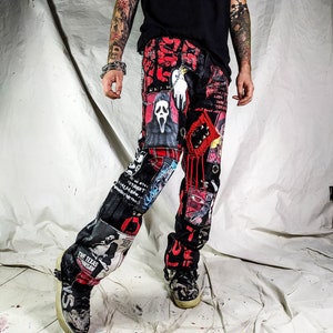 Model showing a custom made black pair with prints containing various horror movies, red and black patchwork, abstract painting, studs, red laces hanging down, chain and eyelets.