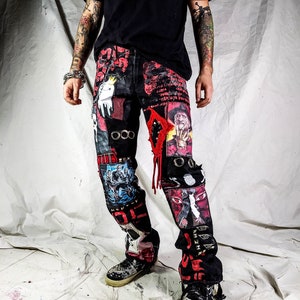 Model showing a custom made black pair with prints containing various horror movies, red and black patchwork, abstract painting, studs, red laces hanging down, chain and eyelets.