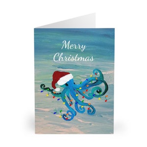 Santa octopus in Holiday lights Christmas beach coastal art Greeting cards  (5 Pack) approx size 5 x 8 inches.