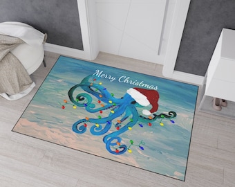 May include: A rectangular doormat featuring a blue octopus wearing a Santa hat and wrapped in colorful Christmas lights. The words "Merry Christmas" are written above the octopus. The background has a blue and white watercolor effect.