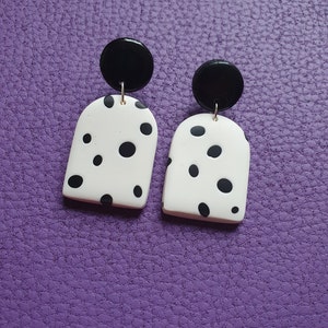Black and white polka dot earrings made from polymer clay