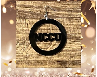 May include: Black acrylic hoop earrings with the word "NCCU" in white lettering.