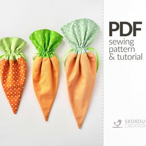 May include: Three carrot-shaped drawstring bags in varying sizes. The bags feature orange fabric with white polka dots or a textured pattern, green tops, and green drawstrings. The image includes the text "PDF sewing pattern & tutorial".