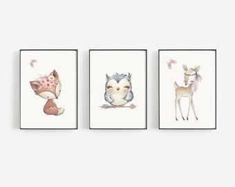 May include: Three framed prints featuring watercolor illustrations of woodland animals. The prints feature a fox with a floral crown, an owl with a pink arrow, and a deer with a feather headdress.