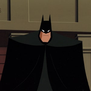 May include: An animated image of Batman, a DC Comics superhero, standing in front of a brick wall. He is wearing a black cape and cowl, with white eyes and a stern expression. The Warner Bros. logo is in the upper left corner.