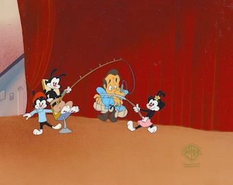 May include: A cartoon scene with four characters. Two black and white cartoon characters with red hats are fishing with a long wooden pole. A man in a blue shirt is caught in a net. The fourth character is a black and white cartoon character with a yellow flower in her hair. The scene is set on a stage with red curtains in the background.