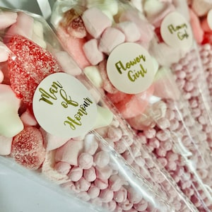 May include: Pink and white candy cones with labels that say "Man of Honour" and "Flower Girl".