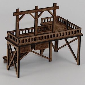 May include: A wooden model of a raised platform with a wooden railing and a wooden frame above. The platform has a wooden staircase leading up to it.