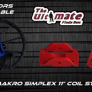 May include: Red and black 11 inch coil stiffener for the Nokta Makro Simplex metal detector. The stiffener is made of plastic and has a textured surface. The text "The Ultimate Finds Box" is visible in the background.