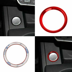 May include: A circular red metal trim ring designed for a car engine start-stop button. The ring features a smooth, glossy finish on the front and an adhesive backing on the reverse side, shown installed around a silver start-stop button.