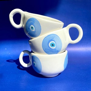 Happy handmade ceramic evil eye mug