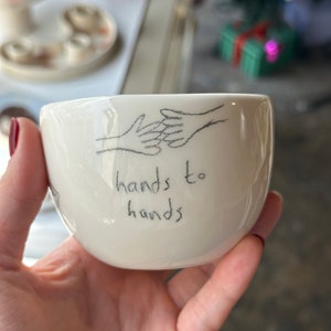 Handmade ceramic hand to hand mug