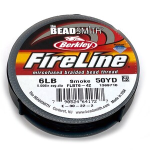 May include: A spool of black FireLine microfused braided bead thread by Berkley. The label reads "6LB Smoke 50YD 0.006in avg.dla FLBT6-42 1389710 The BEADSMITH Carteret, NJ www.beadsmith.com Made in USA".