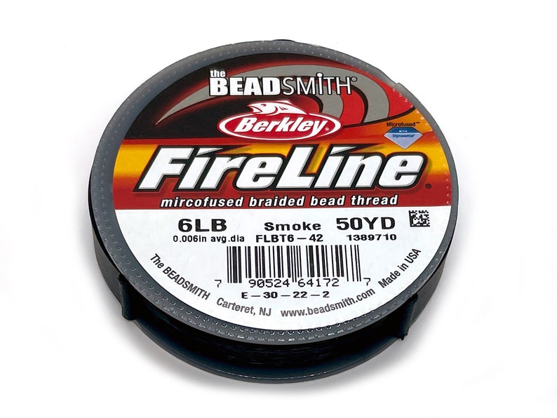 May include: A spool of black FireLine microfused braided bead thread by Berkley. The label reads "6LB Smoke 50YD 0.006in avg.dla FLBT6-42 1389710 The BEADSMITH Carteret, NJ www.beadsmith.com Made in USA".