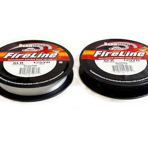 May include: Two spools of Berkley FireLine microfused braided bead thread. The spool on the left is Crystal color and the spool on the right is Smoke color. Both spools are 6lb test and 125 yards.