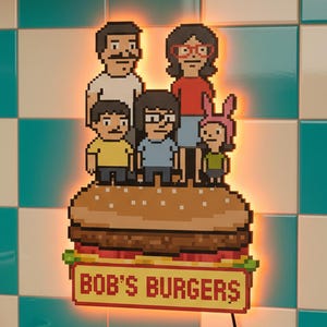 May include: A pixelated light-up sign featuring the Bob's Burgers family atop a burger. The sign has a warm orange glow and the text "BOB'S BURGERS" at the bottom. The background is a teal and white checkered pattern.