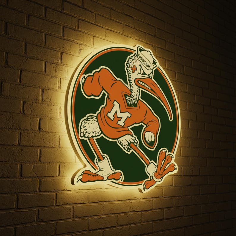 May include: A lighted sign featuring the University of Miami Hurricanes mascot, a cartoon pelican in an orange jersey with a large green circle background. The pelican is wearing a hat that says "Hurricanes". The sign is mounted on a brick wall.
