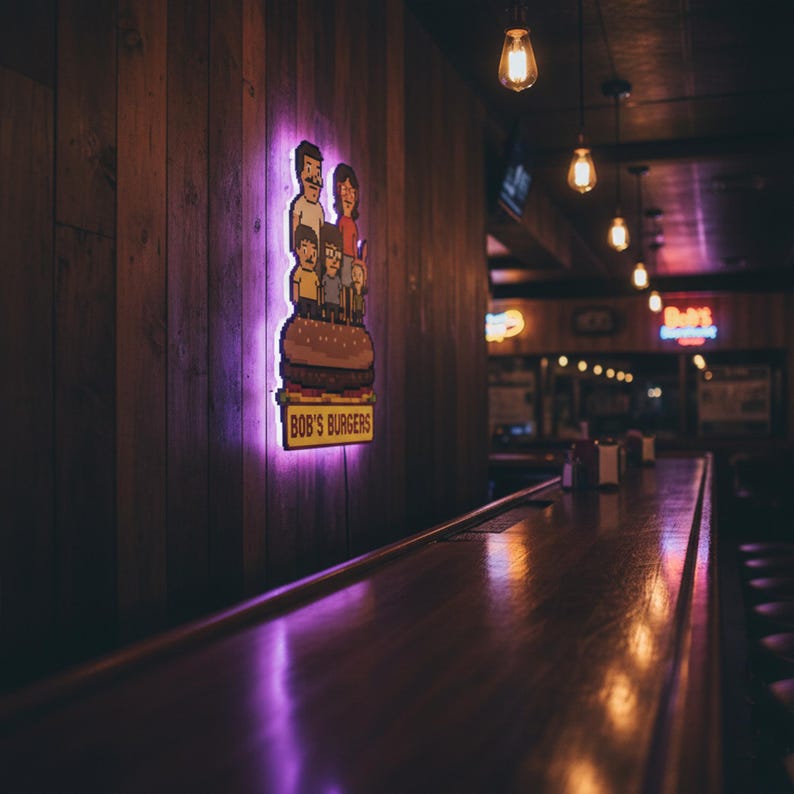 May include: A neon sign featuring the Bob's Burgers family atop a burger, with the text "BOB'S BURGERS". The sign is mounted on a wooden wall, with a purple glow around the sign. The scene is set in a dimly lit restaurant.
