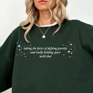 Defying Gravity and Holding Space Lyrics Sweatshirt Ariana Cynthia Finger Hold Gravity Wicked Movie Gift Idea Glinda Elphaba Queer LGBT