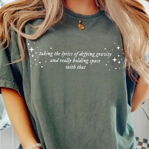 Lyrics Defying Gravity and Holding Space Shirt, Ariana Cynthia Finger Hold, Defying Gravity Meme Wicked Movie Gift Tshirt Glinda Elphaba Tee