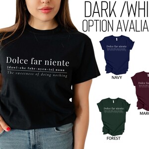 May include: A black t-shirt with white text that reads "Dolce far niente" and a definition of the phrase. The shirt is available in navy, maroon, and forest green.