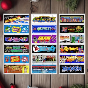 May include: A set of 18 vintage arcade game cabinet stickers. The stickers feature colorful graphics and text, including the names of popular arcade games like Asteroids, Galaxian, Ms. Pac-Man, and Donkey Kong.