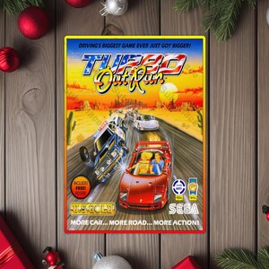 May include: A vintage Turbo OutRun video game box featuring a red sports car and a blue car flipping over on a desert highway. The box has the text "DRIVING'S BIGGEST GAME EVER JUST GOT BIGGER!" and "MORE CAR... MORE ROAD... MORE ACTION!"