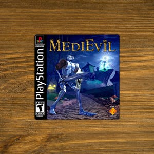 May include: A PlayStation video game case for MediEvil featuring a skeletal knight in armor holding a sword on the front cover. The artwork displays a dark, night-time landscape with a glowing magical orb and the ESRB Teen rating symbol.