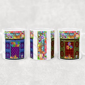 May include: White ceramic mug featuring a colorful arcade game design. The design includes the game title "BUBBLE MOVE" and a pixelated game scene with colorful bubbles and characters. The mug has a white handle.