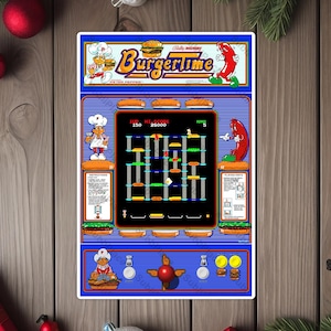 May include: A retro arcade game cabinet with a blue and white design. The game is called "BurgerTime" and features a chef, a hamburger, and a hot dog. The game screen shows a level with a score of 150 and 25000. The game is set on a wooden surface.