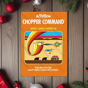 May include: An orange video game cartridge for the Atari system. The cartridge features the game title "CHOPPER COMMAND" and a colorful graphic of a helicopter, vehicles, and explosions. The Activision logo is at the top.