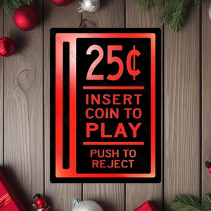 May include: A black and red sign with the text "25¢ Insert Coin to Play Push to Reject".